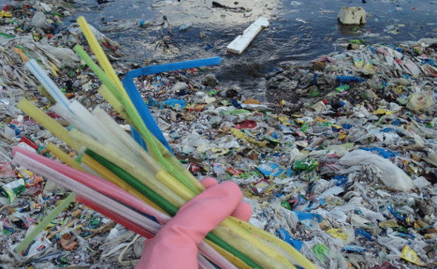 Plastic straws and plastic debris beach pollution