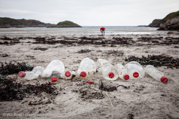 Empty plastic Coke bottles discarded on a beach