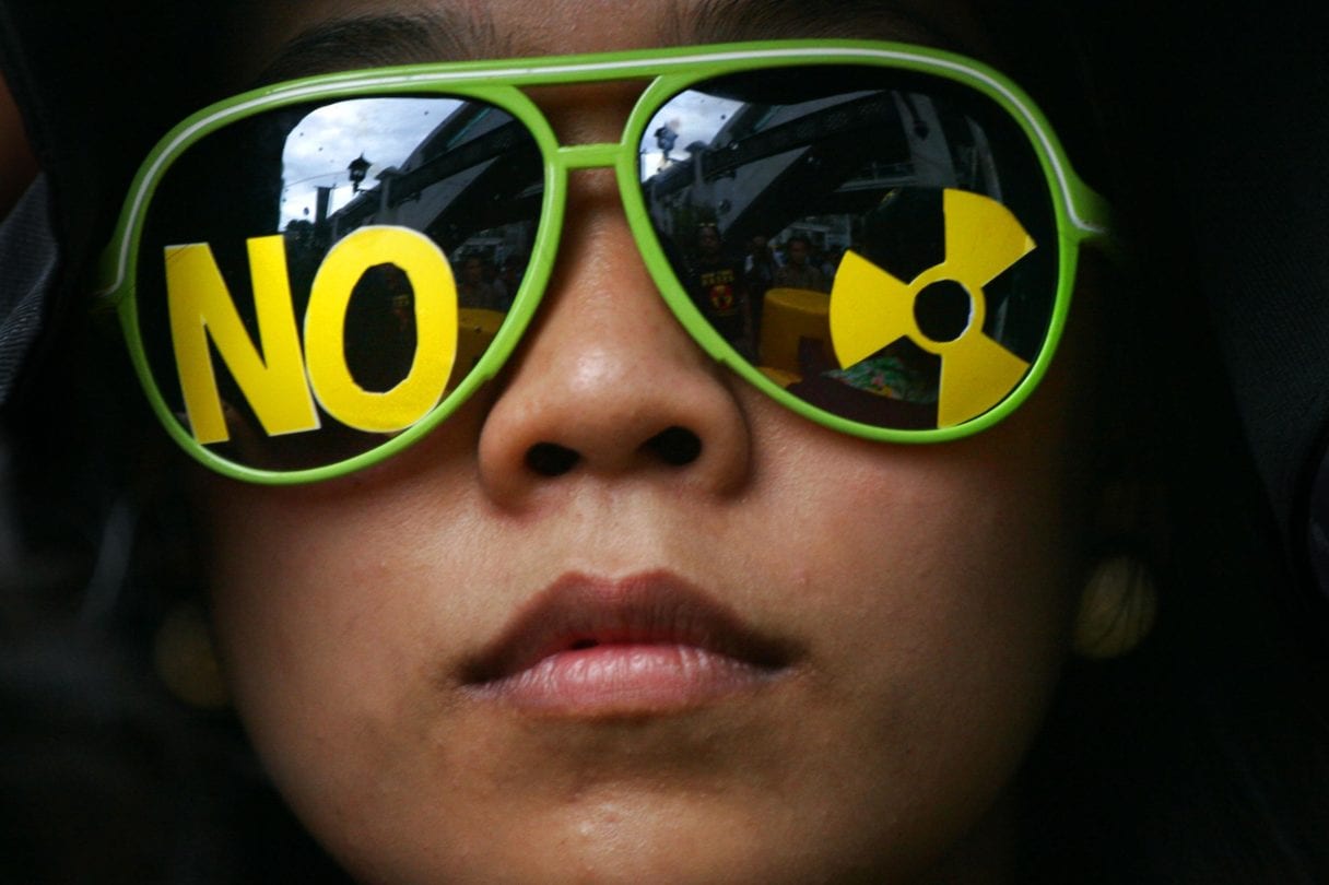 person with sunglasses with "no nuclear" symbol on them