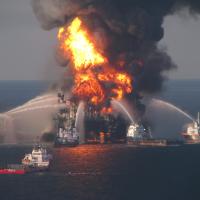 Fire response boats hosing water onto the burning deepwater horizon oil rig