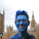 Michelle with her face painted blue with Houses of Parliament in the background.