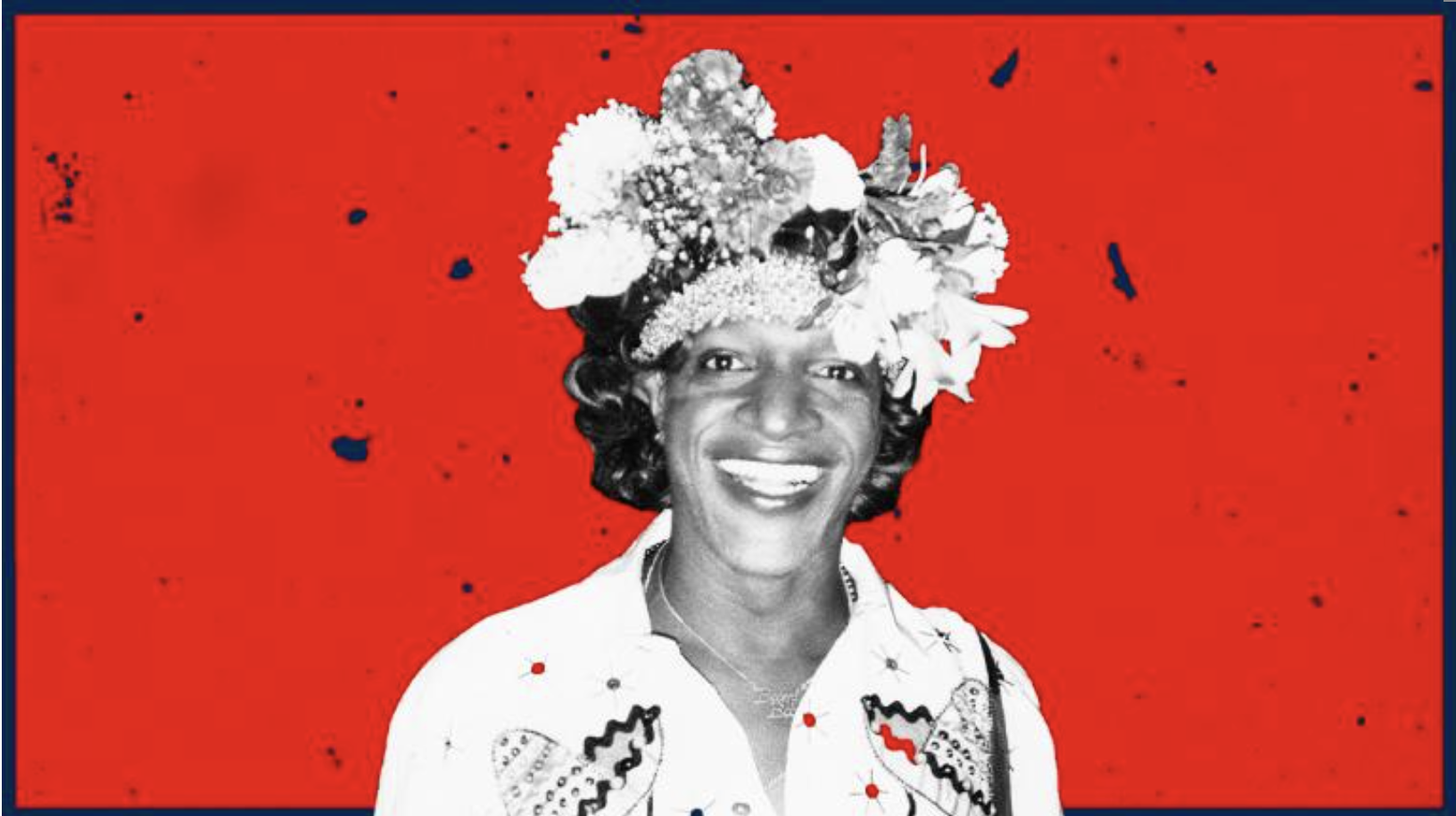Black and white photo of Marsha P Johnson smiling into the camera and wearing an elaborate crown of flowers