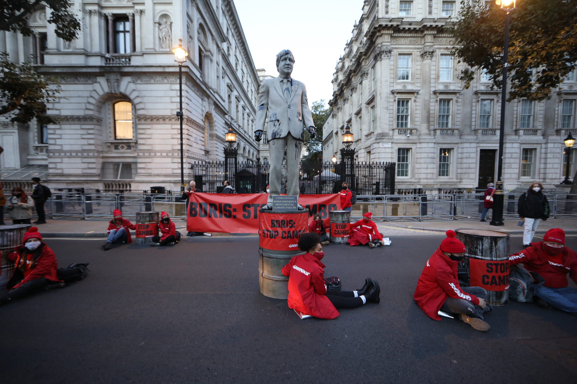 Activists block Downing street with a statue of Boris Johnson dripping in oil