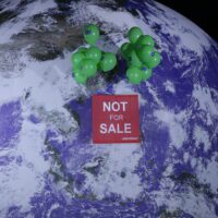 Lifted by green balloons, a red banner floats in front of a giant realistic model globe reading 'Not for sale'.