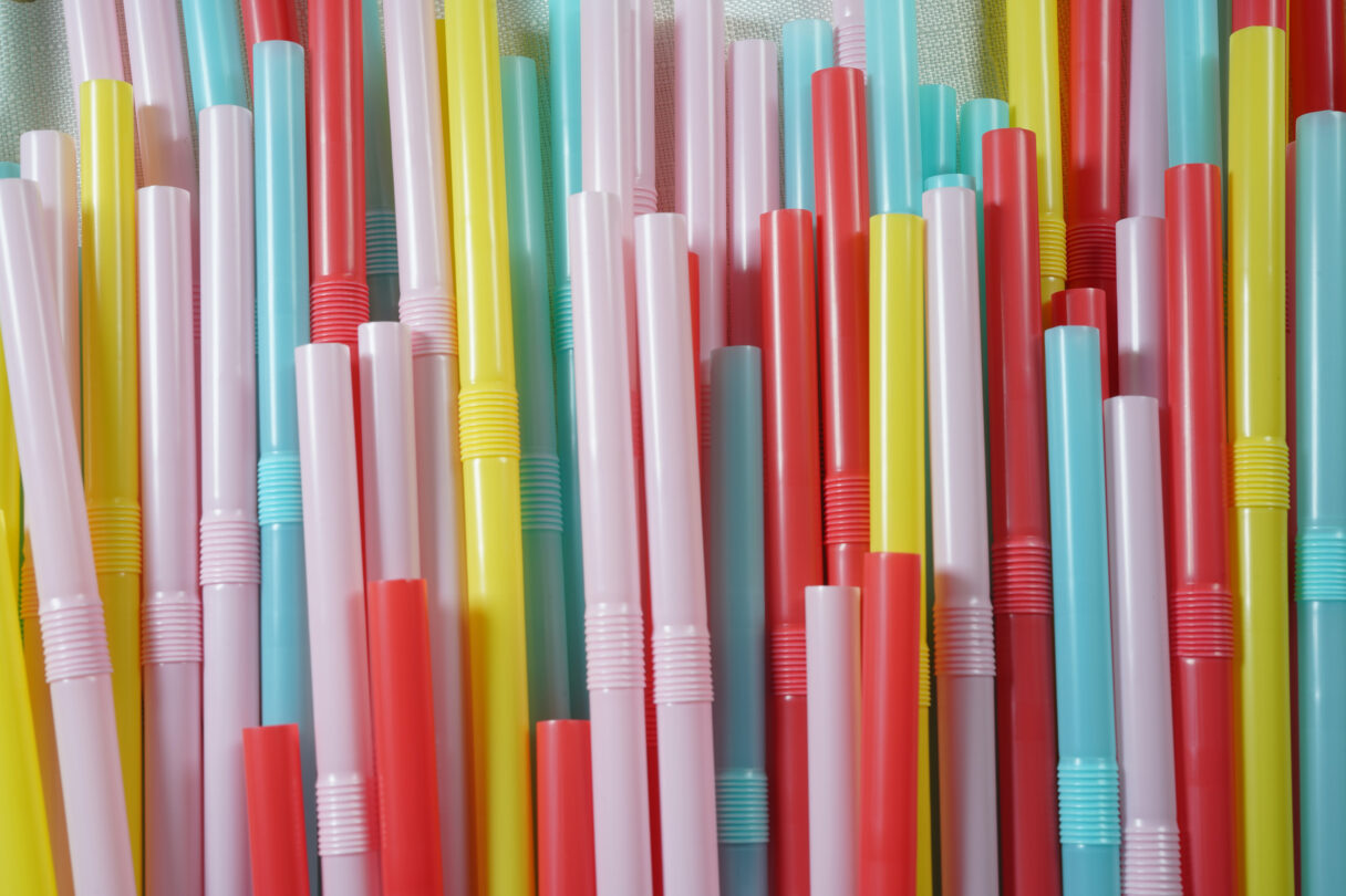 Closeup of colourful plastic straws bunched together