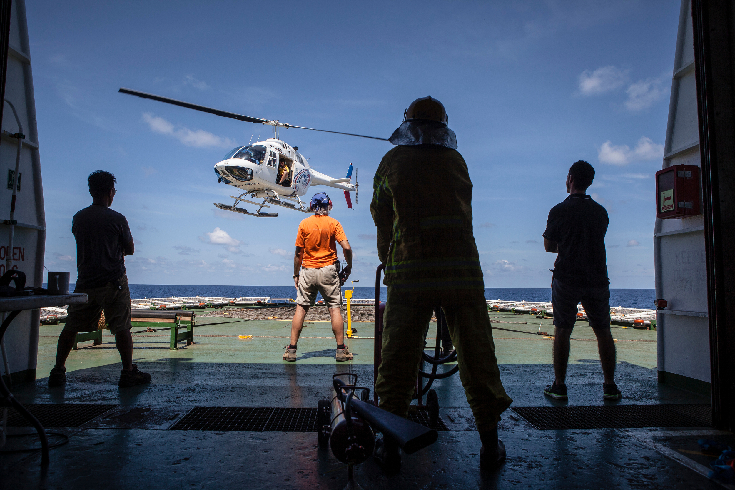 The crew of Greenpeace ship Esperanza prepare for a search flight over the Indian Ocean. 