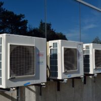 A row of air conditioners. Refrigerants using HFCs cause climate change.