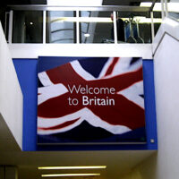 A large sign saying 'Welcome to Britain' against a Union flag