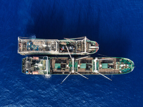 Aerial photo of two squid jiggers sailing in tandem on a deep blue ocean