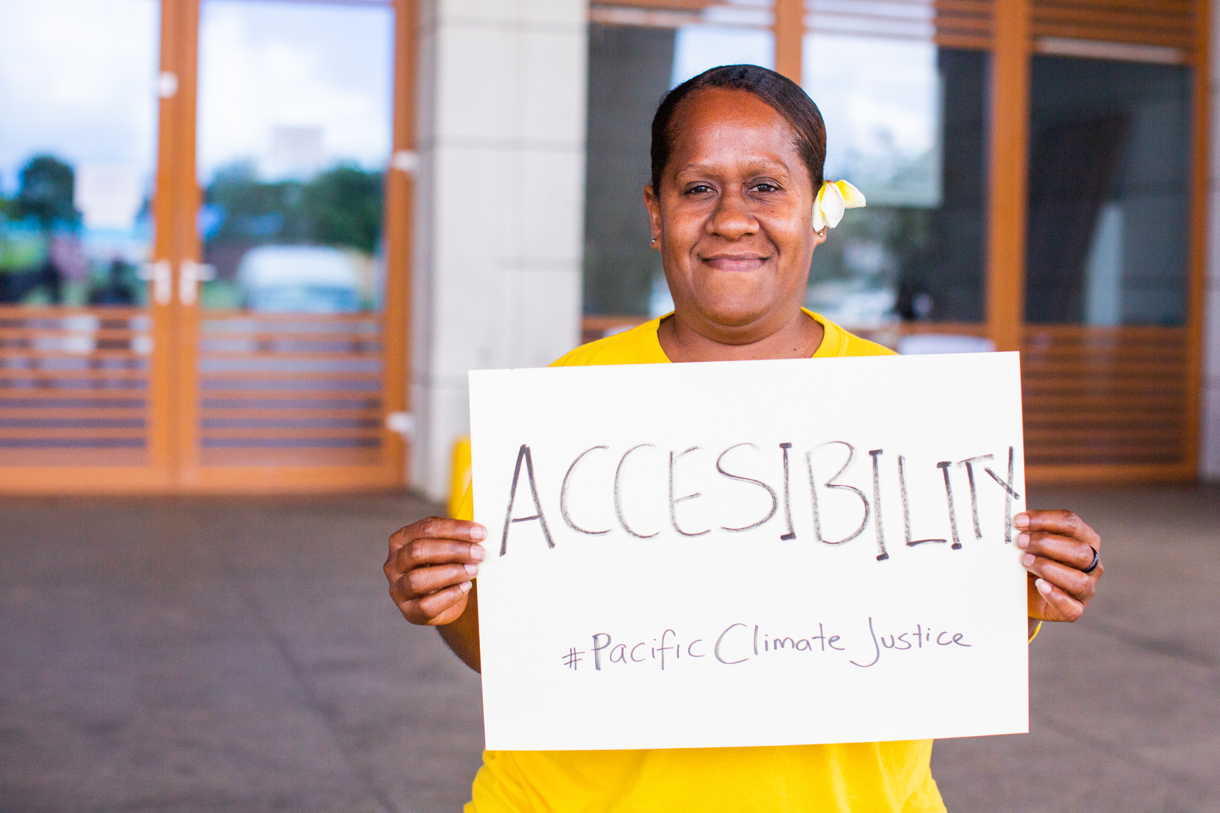 Portrait of woman holding a sign saying 'Accessibility'