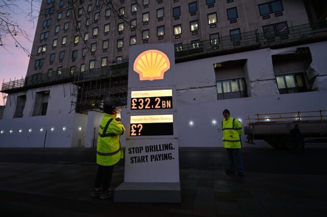Greenpeace UK activists set up a mock petrol station price board, with Shell logo, featuring their £32.2 billion record profits on one section, and a question mark next to "payment for climate damage' on another panel. The activists set the board up outside Shell's London HQ at first light on Thursday 2 February, as Shell announced their breath-taking profits.
