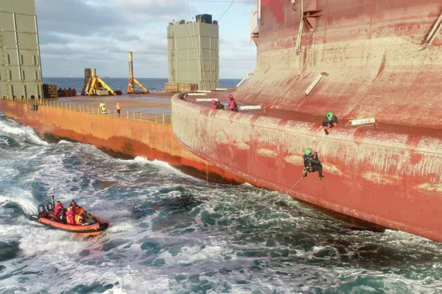 Two more Greenpeace climbers board the Shell oil platform that is being transported to an oilfield north of the Shetland Islands.