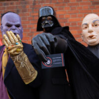 People in Thanos, Darth Vader and Dr Evil costumes pose for the camera