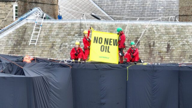 Climbers cover Rishi Sunak’s mansion in sheets of oil-black fabric and hold a banner saying no new oil