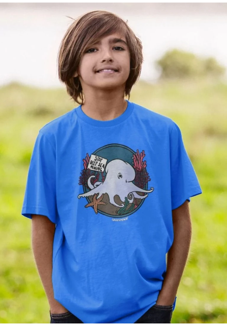Child model wears a tshirt with an octopus design in muted colours.