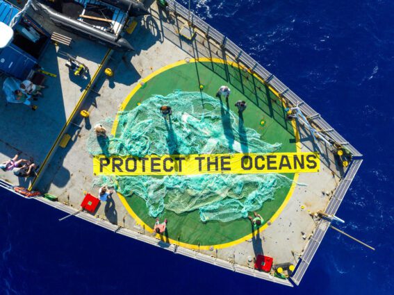 Aerial view of the Arctic Sunrise deck with a ‘ghost net’ that was retrieved from the Sargasso Sea on display and a 'Protect the Oceans' banner.