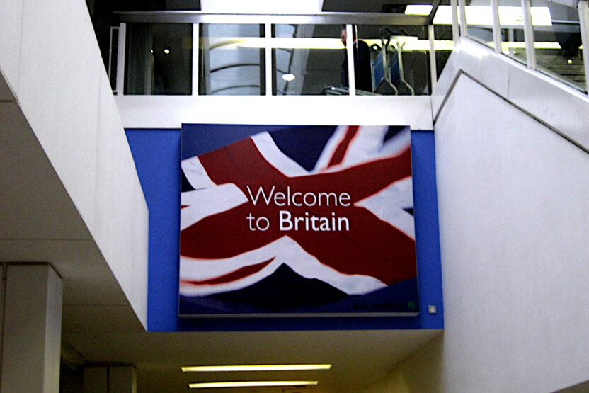 A large sign saying 'Welcome to Britain' against a Union flag