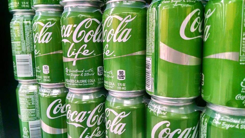 Coca-cola life green cans stacked together
