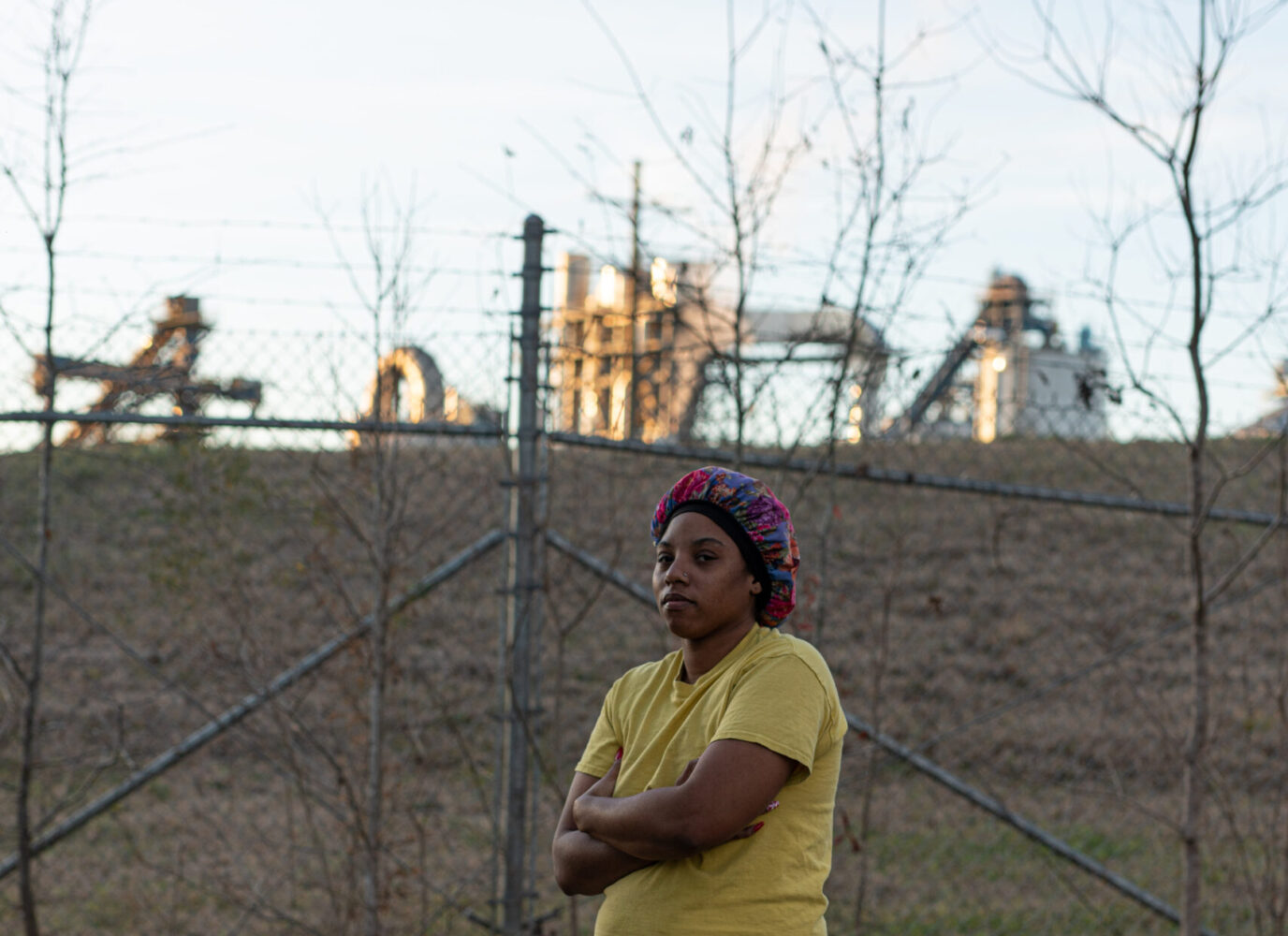 Gloster, Mississippi, resident Jasmine Jenkins stands in front of the Drax plant Amite Bioenergy, which began operations next to her community in 2014.