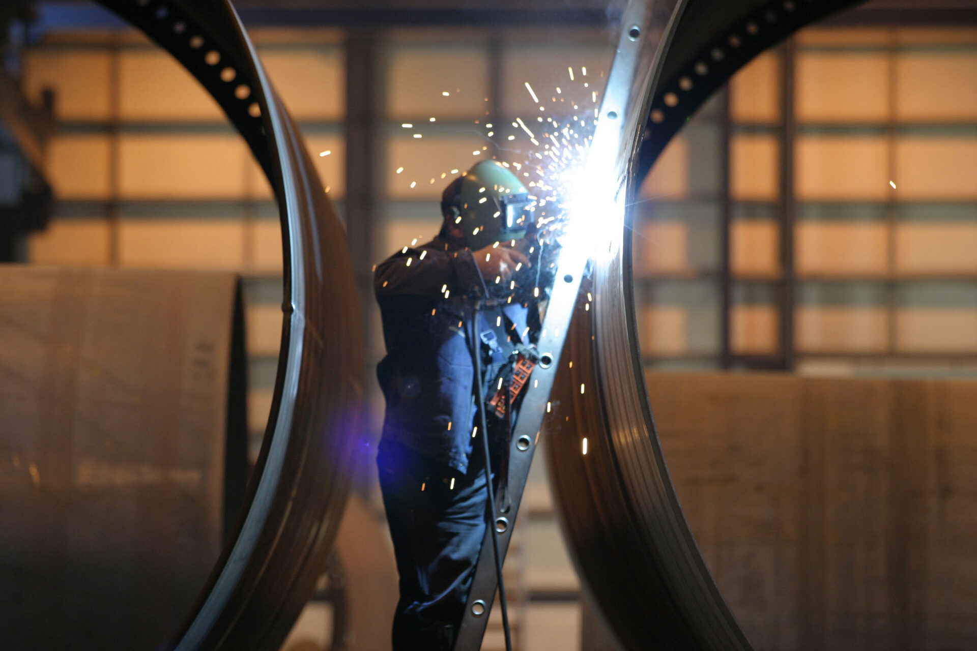 A worker welding wind turbine components at a factory in Leith.