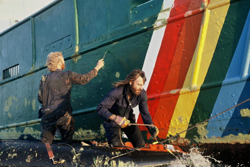 Crew of the Rainbow Warrior work on the side of the ship during campaign to defend grey seals from  Norwegian sealers.