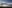 Wind turbines with sunshine and clouds in the background