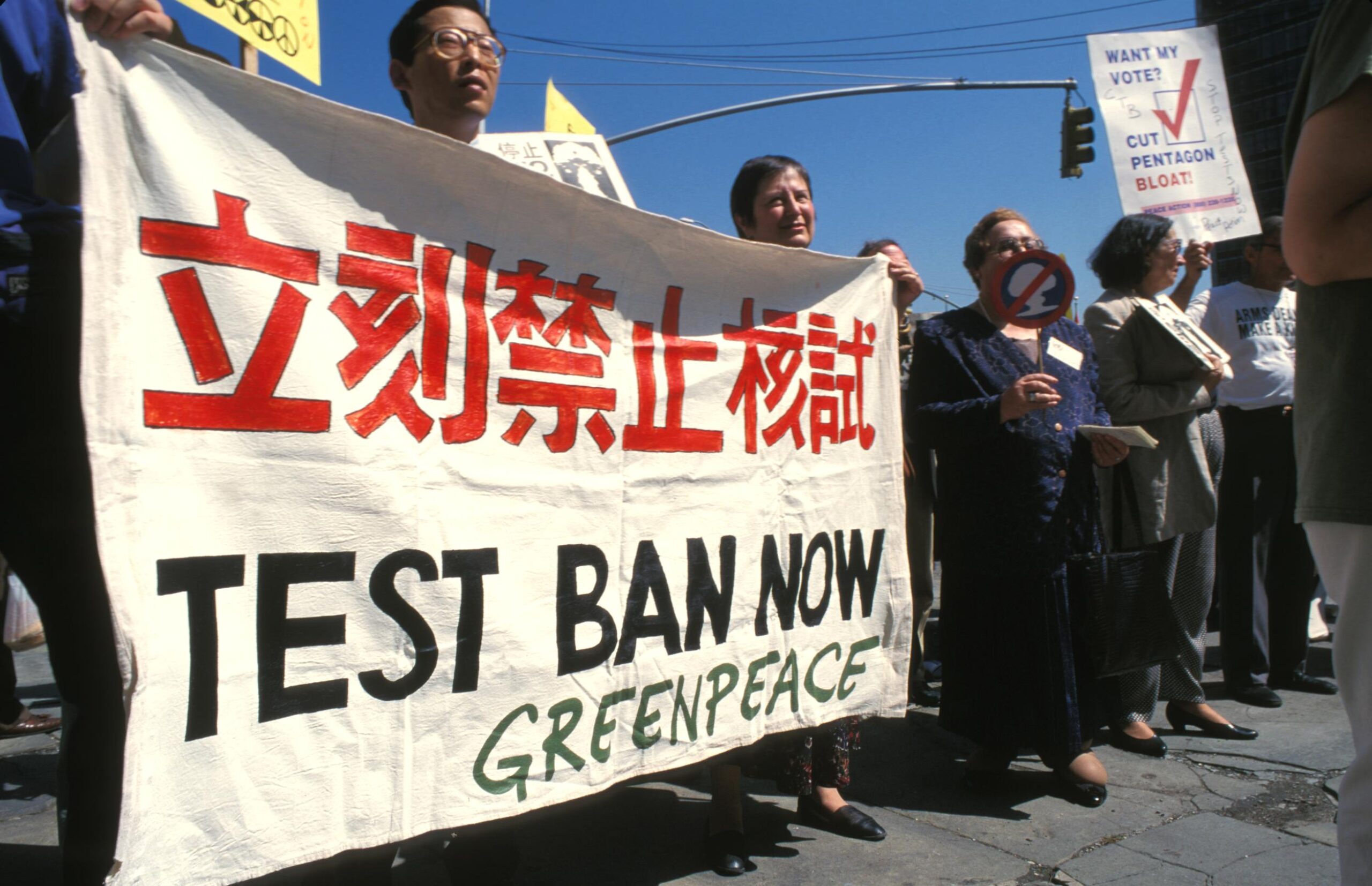 Protestors hold up a banner saying 'test ban now'