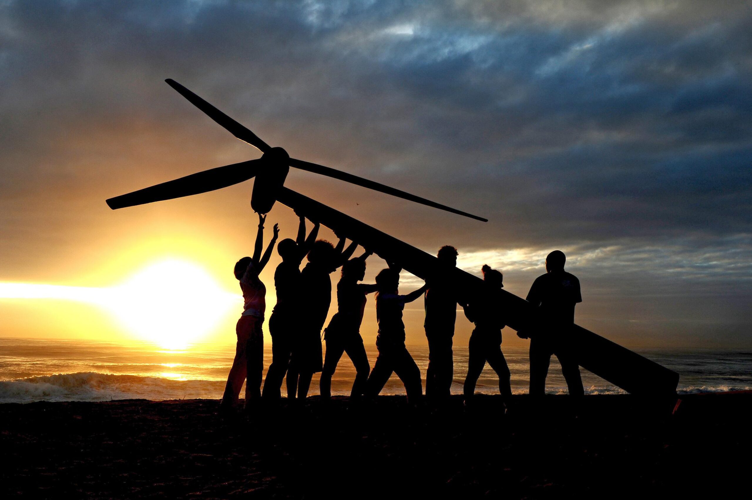 People symbolically raising a Wind Turbine to show the importance of green jobs.