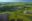 Aerial view of a vast wetland. It's dark pools and lush greenery as far as the eye can see.