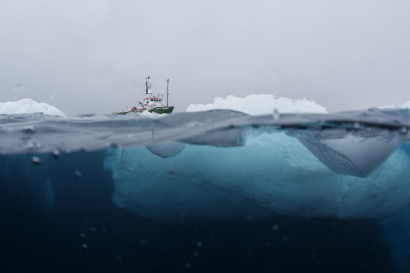 half under water half above water shot of iceberg