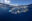 Small shellfish have anchored themselves to a plastic bottle drifting just below the surface of the ocean