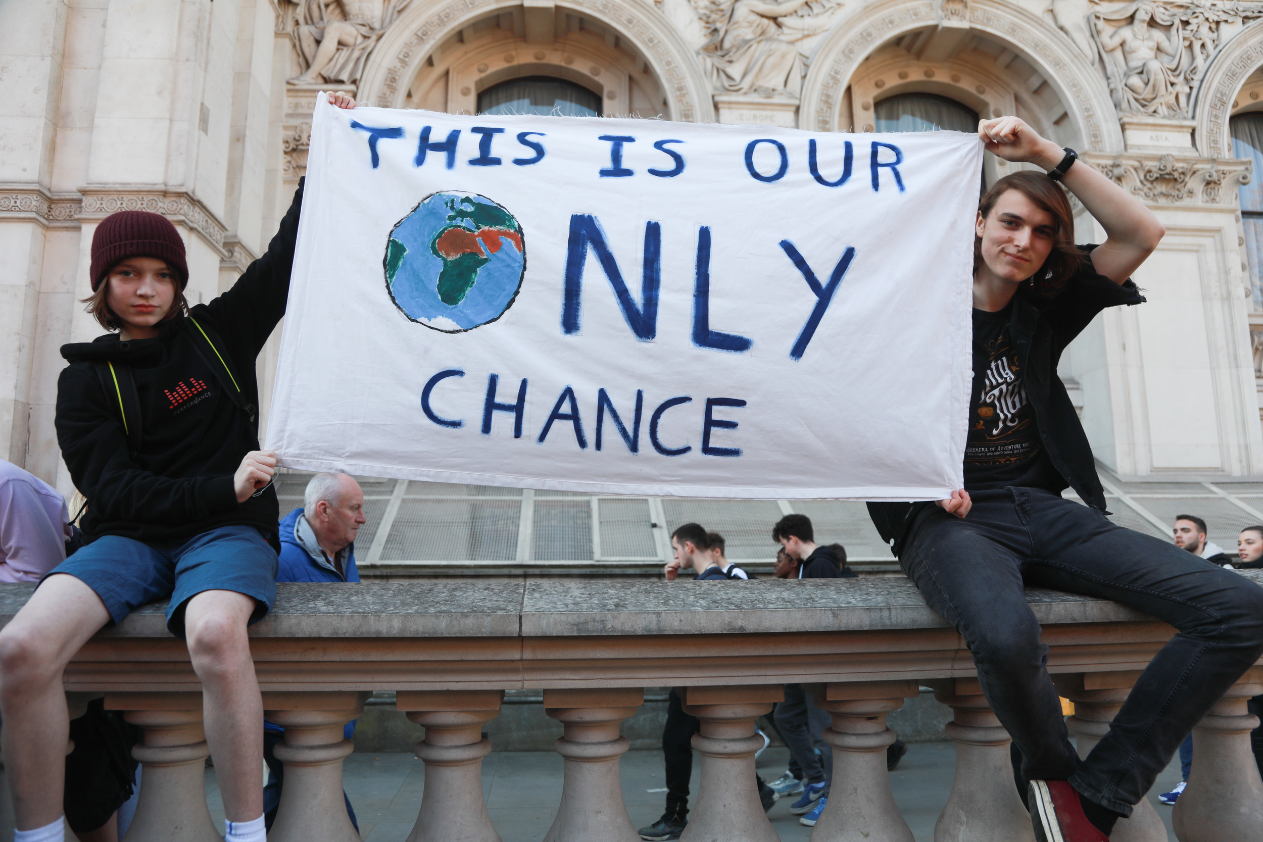 Teenagers at a London School Strike holding a banner reading "This is our only chance"