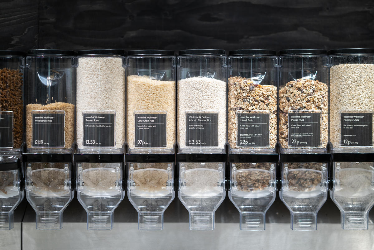 A row of dried food dispensers in a supermarket