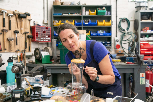 Hannah Davey works on an action prop in the Greenpeace workshop