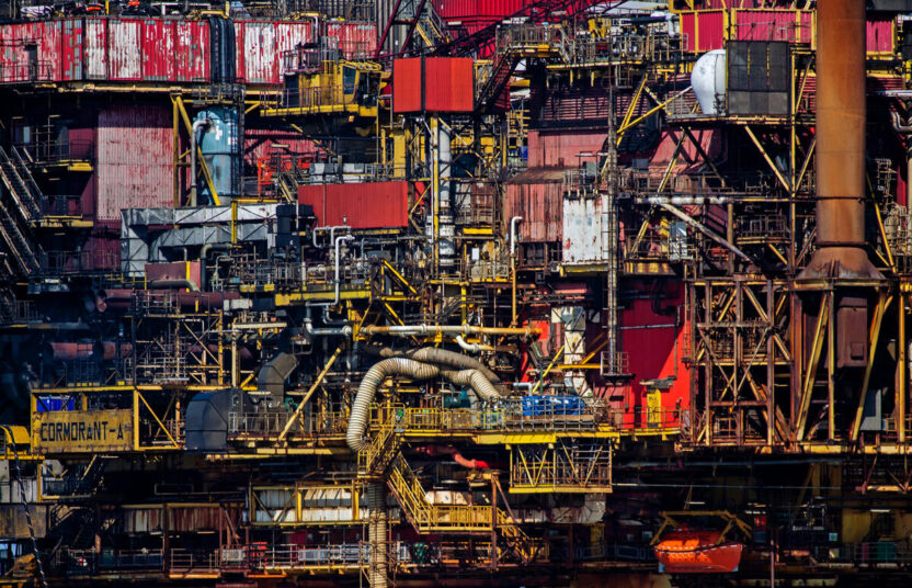 Detail from an oil platform, showing tangled pipework and painted metal panels