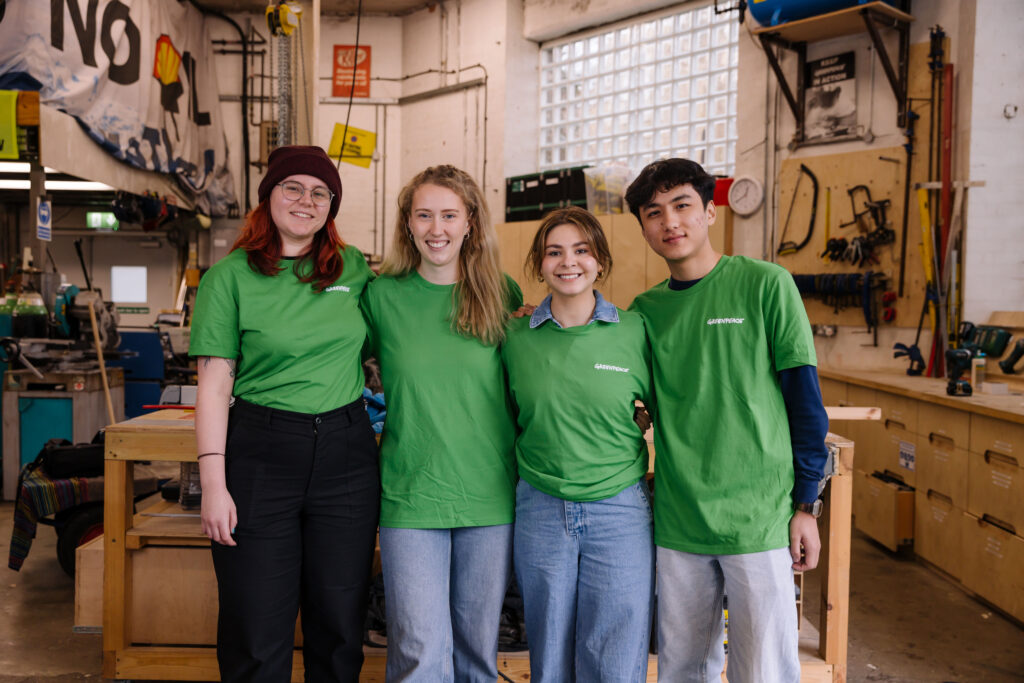 Greenpeace volunteers smile into the camera