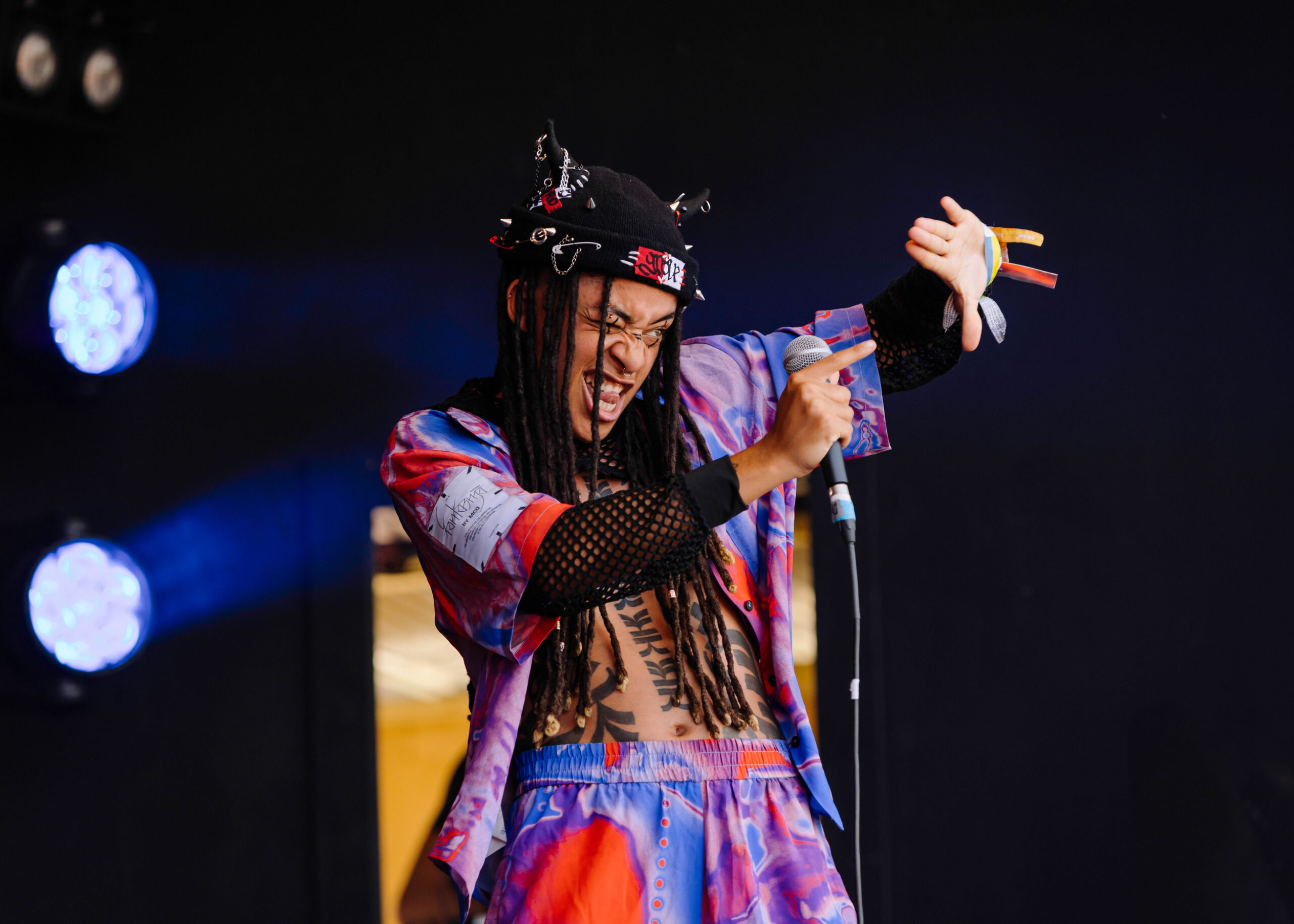 Grove gestures to the audience on stage at Glastonbury.