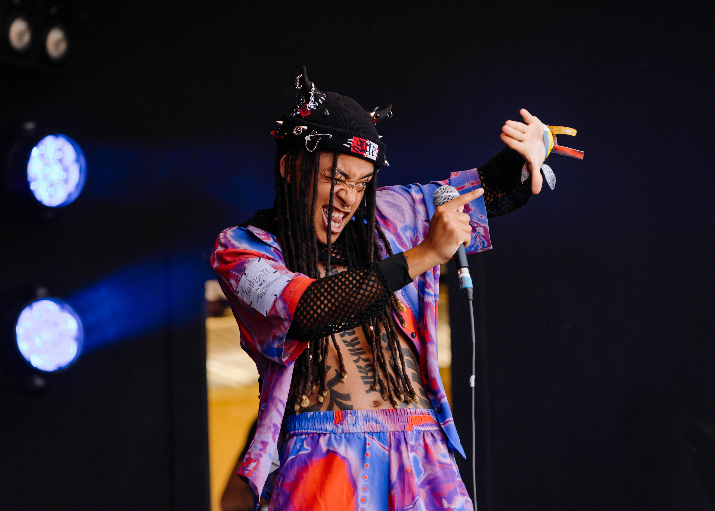 Grove gestures to the audience on stage at Glastonbury.