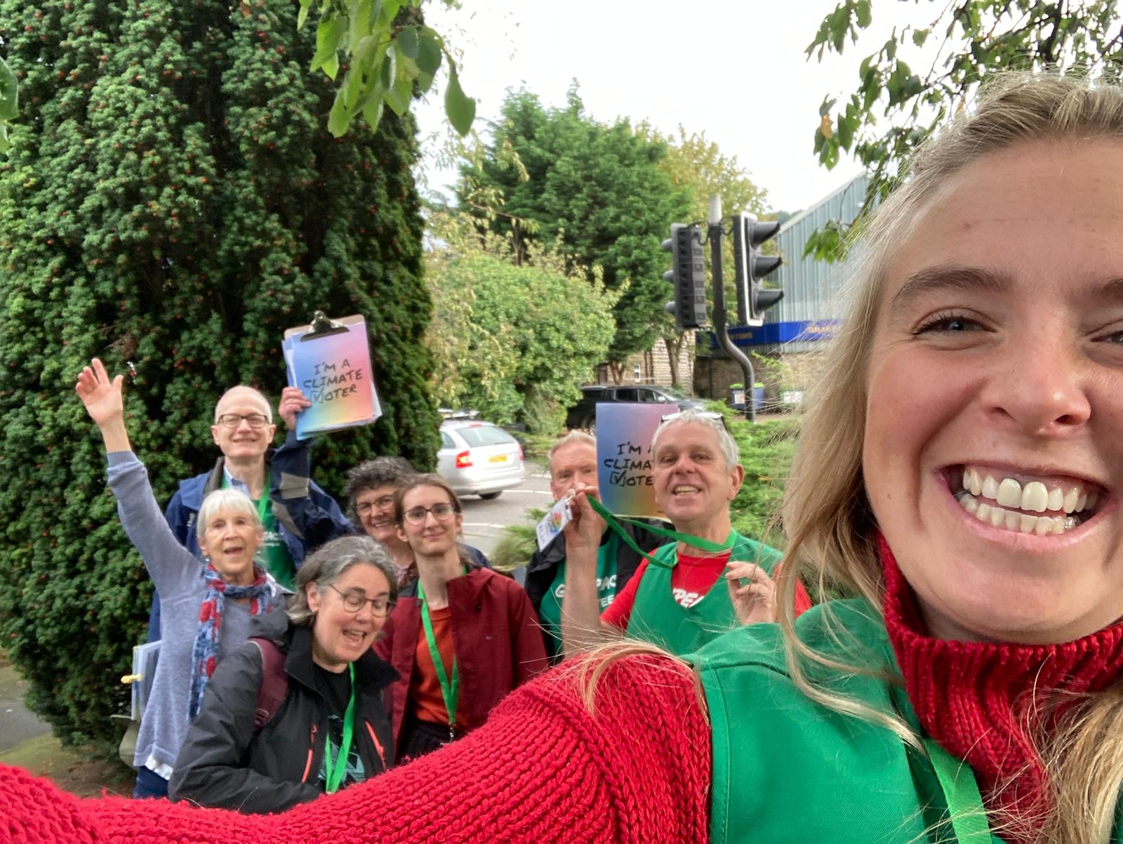 Smiling volunteers take a selfie with Project Climate Vote clipboards