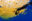 A figure with a camera silhouetted against blue sea and golden sargassum