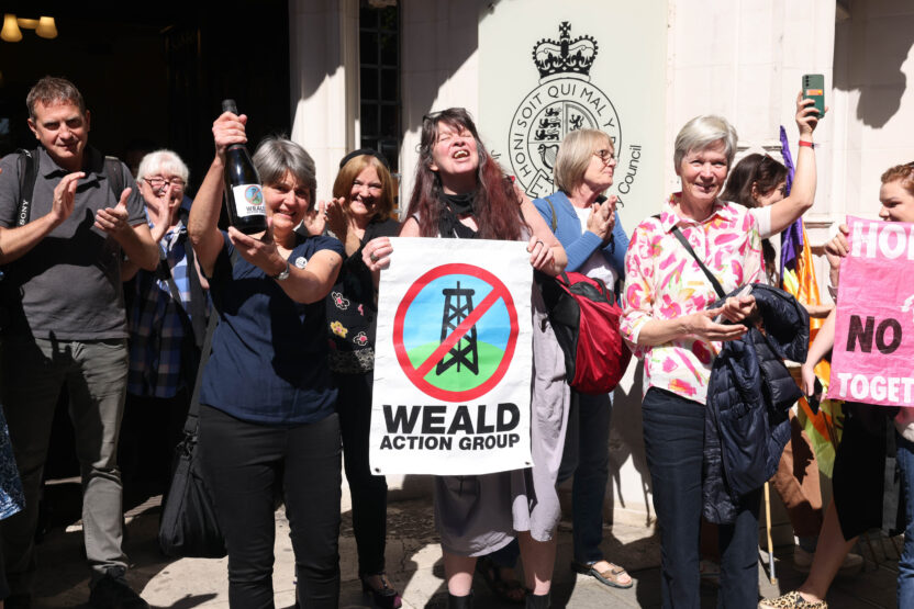 A group of campaigners smiling and cheering outside the Supreme Court.
