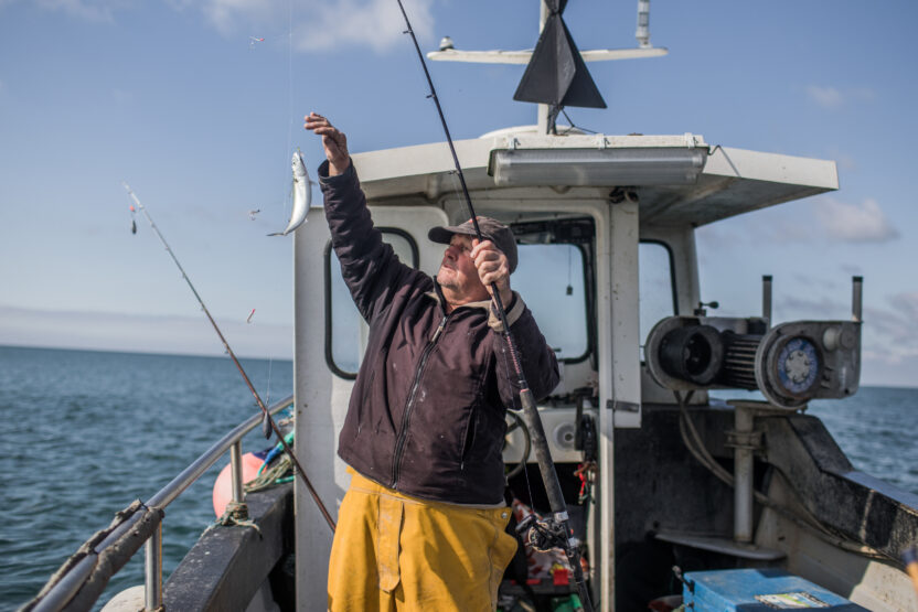 Fisher David Downey catching fish on his boat.