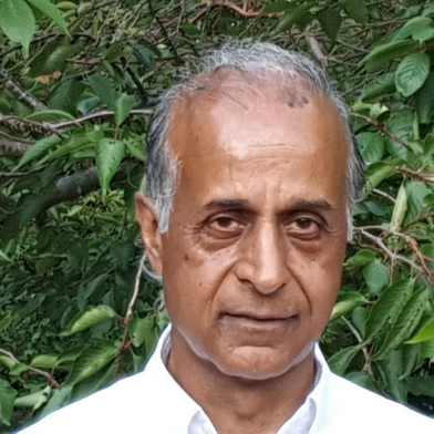 Jasbir Singh in front of lush green foliage