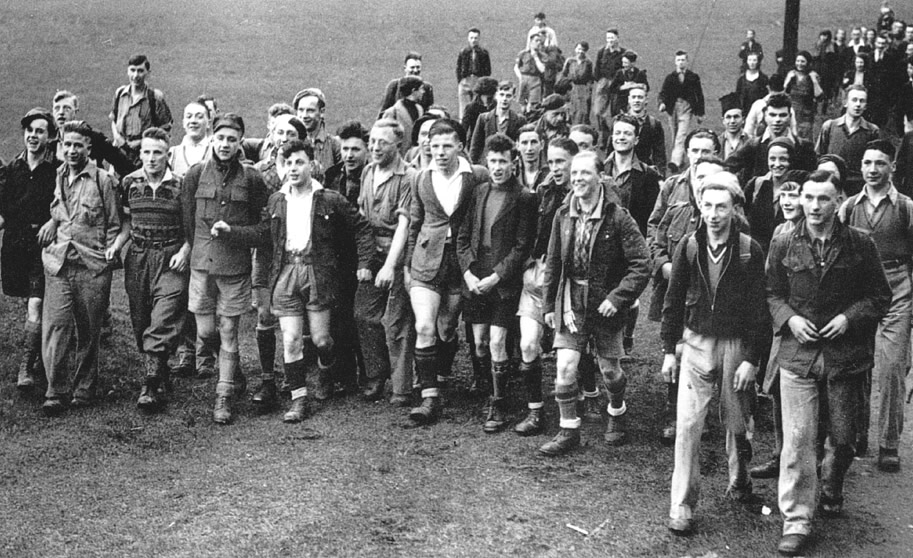 Black and white photo of a smiling group of people walking together
