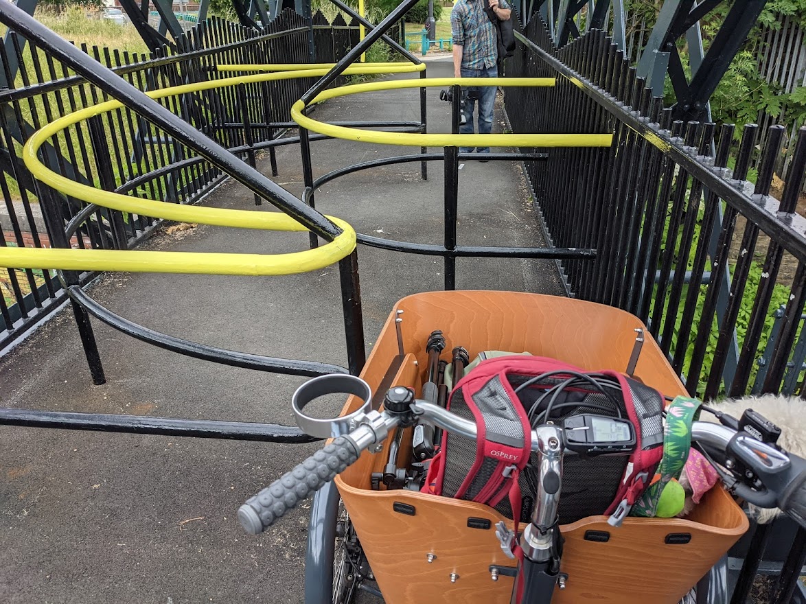Seen from the rider's perspective, a chicane barrier blocks a cargo trike from using a traffic-free path.