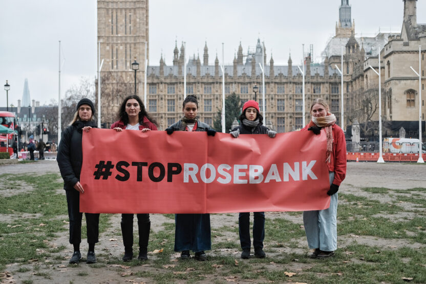 5 people stand in front of the House of Commons holding a big red banner reading #StopRosebank