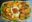 Overhead photo of a sharing platter with spiced fried potates, spinach, guacamole and salsa.