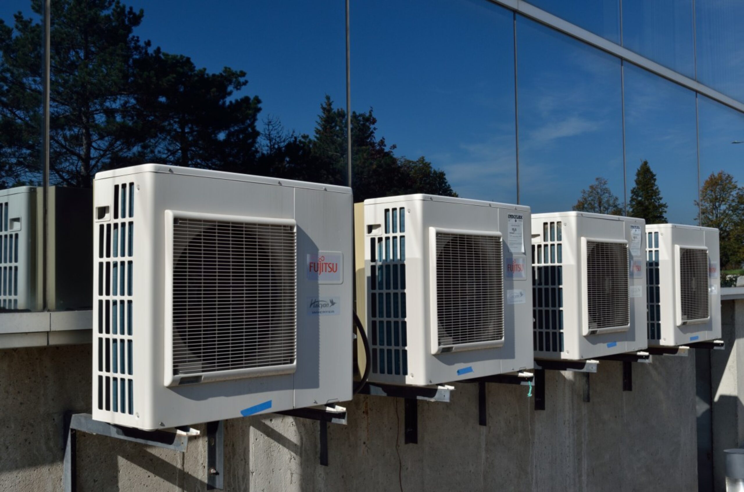 A row of air conditioners. Refrigerants using HFCs cause climate change.