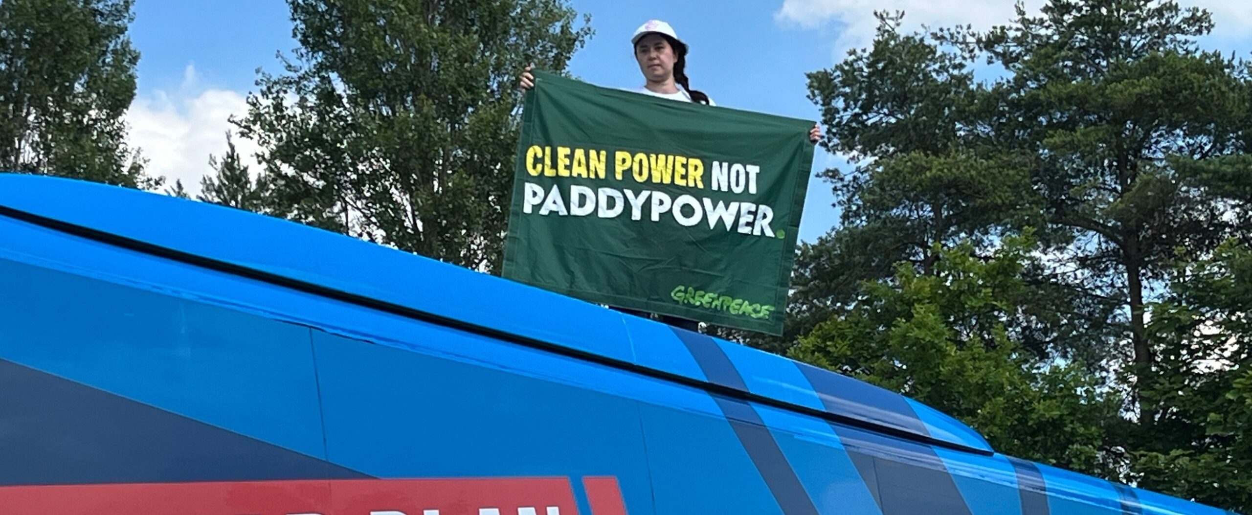 BREAKING: Greenpeace activist climbs on top of Conservative election campaign bus