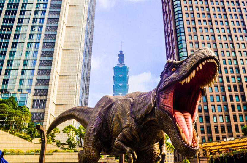 Digital illustration of a t-rex roaring with skyscrapers in the background.
